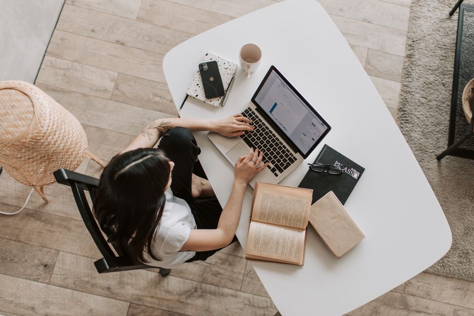 Person working at a laptop on a desk
